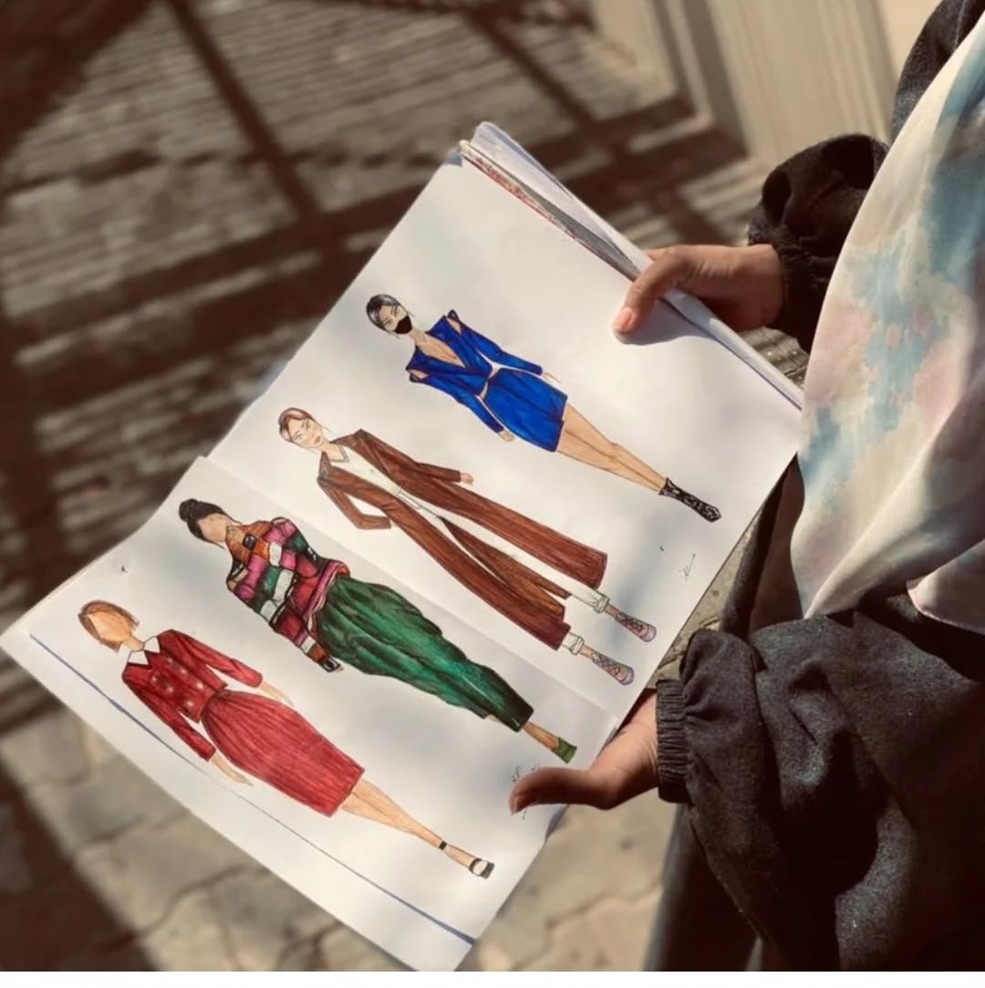 Fashion illustrations held outdoors